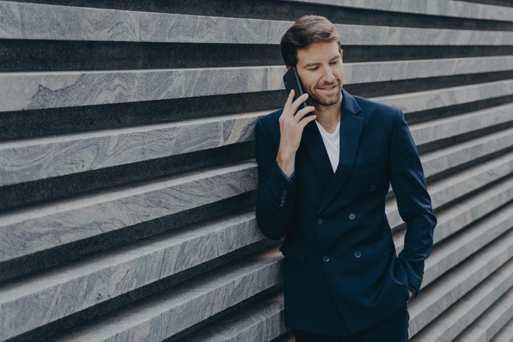 Successful male lawyer makes consultation talks via smartphone